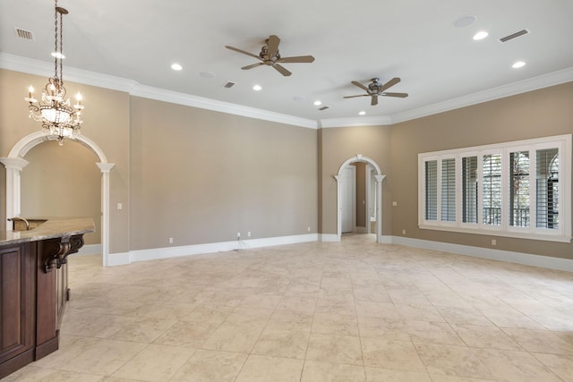 unfurnished room featuring arched walkways, visible vents, and crown molding