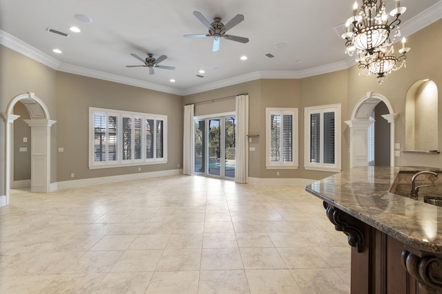 living room featuring light tile patterned flooring, baseboards, arched walkways, and ornamental molding