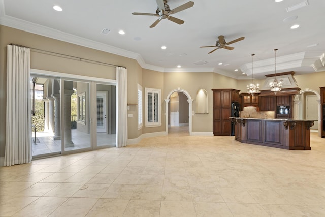 kitchen with visible vents, arched walkways, decorative backsplash, ornamental molding, and oven