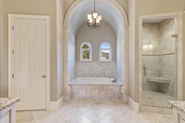 full bath featuring a garden tub, a shower stall, vanity, and an inviting chandelier