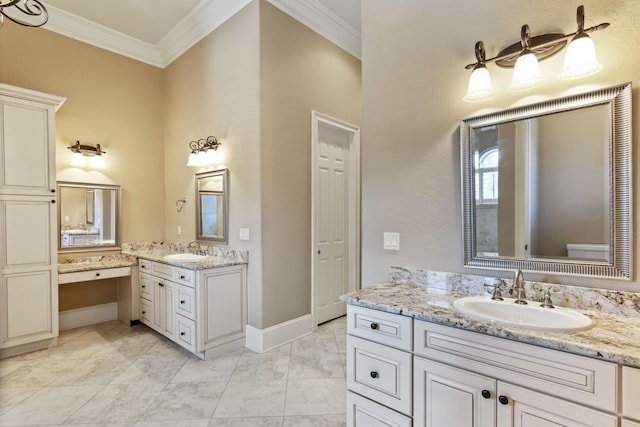 bathroom with crown molding, baseboards, two vanities, and a sink