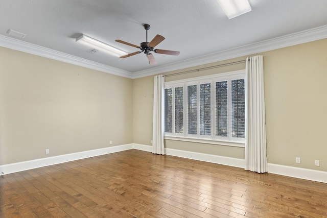 empty room featuring baseboards, crown molding, a ceiling fan, and hardwood / wood-style floors