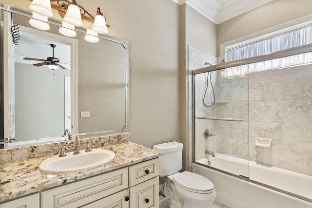 bathroom featuring a ceiling fan, toilet, shower / bath combination with glass door, ornamental molding, and vanity