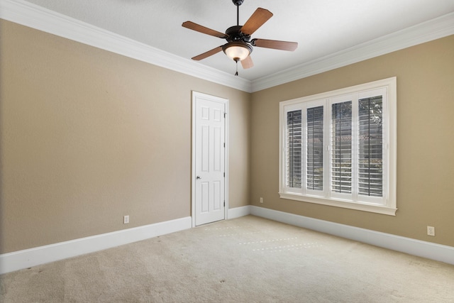 unfurnished room with ceiling fan, ornamental molding, carpet, and baseboards