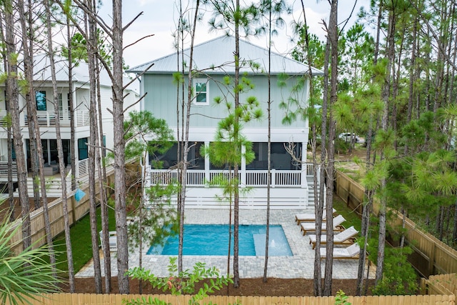 view of pool featuring stairs, a fenced backyard, a sunroom, and a fenced in pool