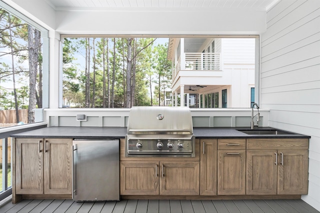 exterior space with exterior kitchen, grilling area, and a sink