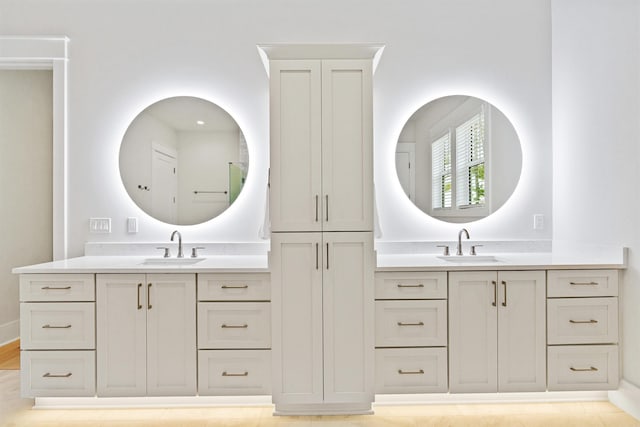 bathroom with two vanities and a sink