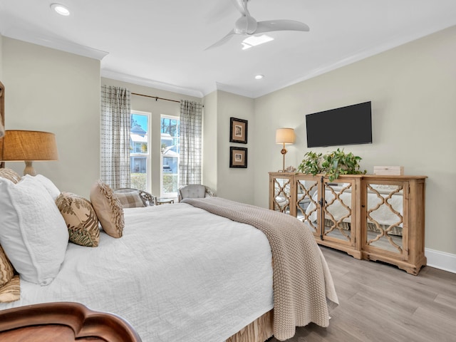 bedroom with baseboards, recessed lighting, wood finished floors, and crown molding