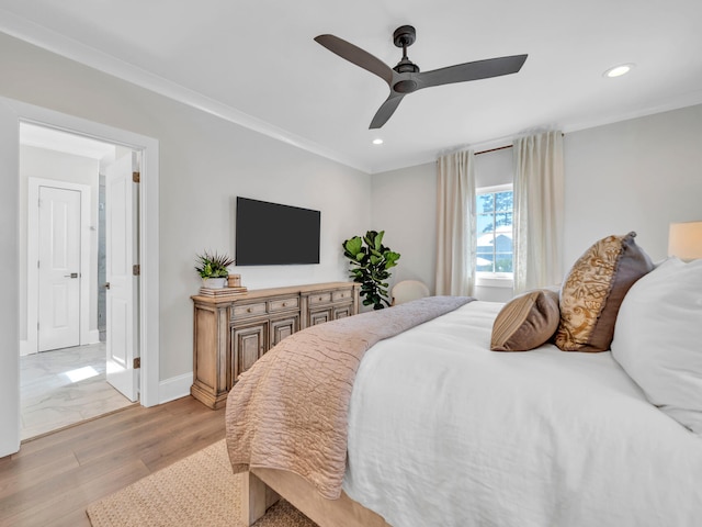 bedroom featuring light wood-style flooring, baseboards, crown molding, and recessed lighting