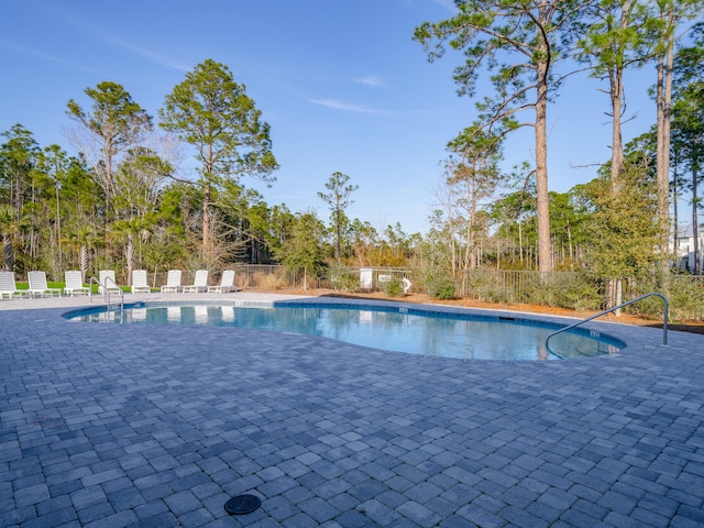 view of pool with a patio area, fence, and a fenced in pool