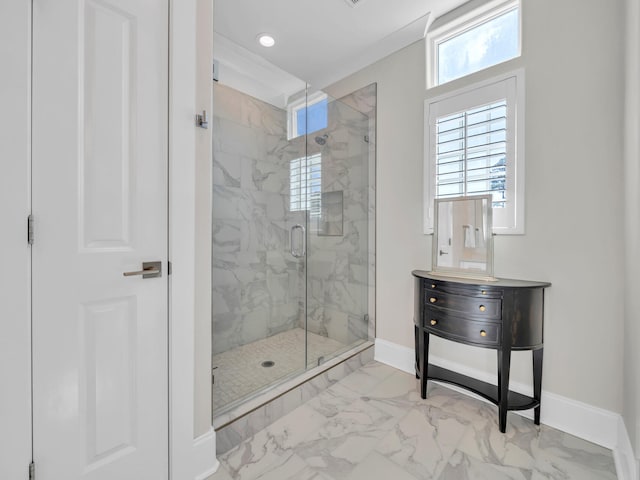 full bathroom with marble finish floor, plenty of natural light, and baseboards