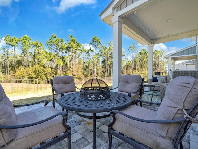 view of patio with a fire pit and fence