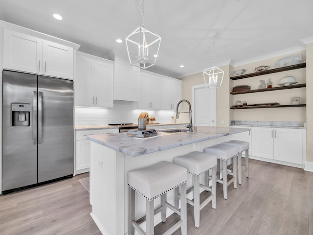 kitchen with stainless steel appliances, a notable chandelier, a sink, and open shelves