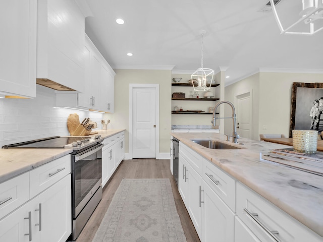 kitchen with crown molding, open shelves, decorative backsplash, appliances with stainless steel finishes, and a sink