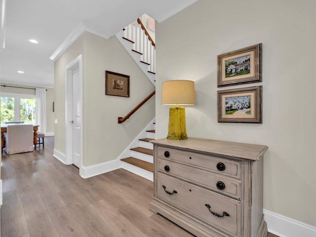 stairs featuring baseboards, wood finished floors, and recessed lighting