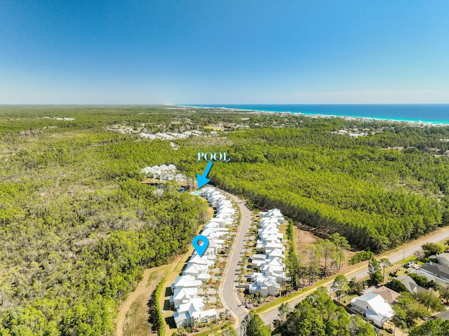 birds eye view of property with a water view and a view of the beach