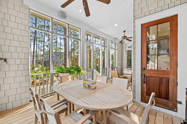 sunroom / solarium with plenty of natural light and ceiling fan