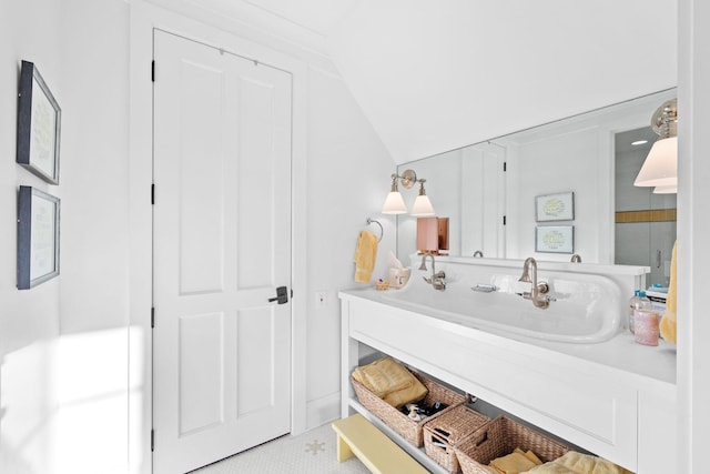 bathroom with vaulted ceiling and vanity