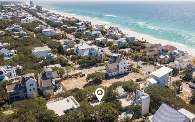 bird's eye view featuring a view of the beach and a water view