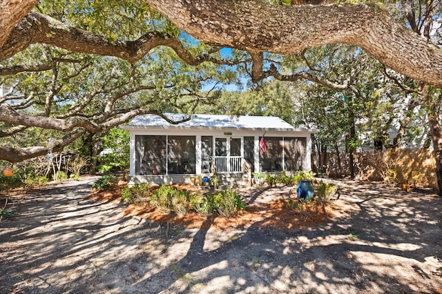 view of front of home featuring a sunroom