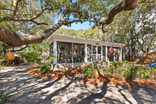 view of front of house featuring a sunroom