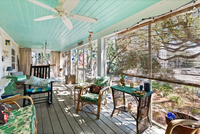 sunroom / solarium with ceiling fan, wood ceiling, and a healthy amount of sunlight