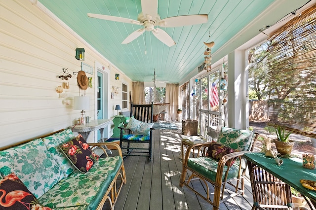 sunroom with wood ceiling and a ceiling fan