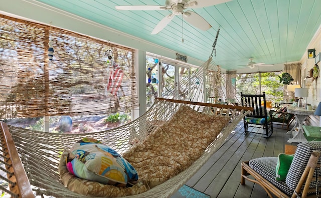 exterior space featuring wooden ceiling, a ceiling fan, and a wealth of natural light