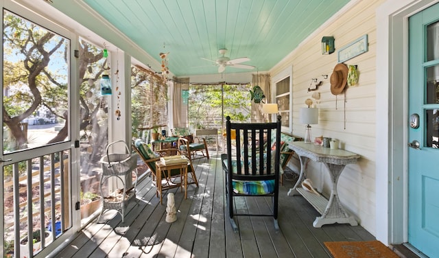 sunroom / solarium with wooden ceiling and ceiling fan