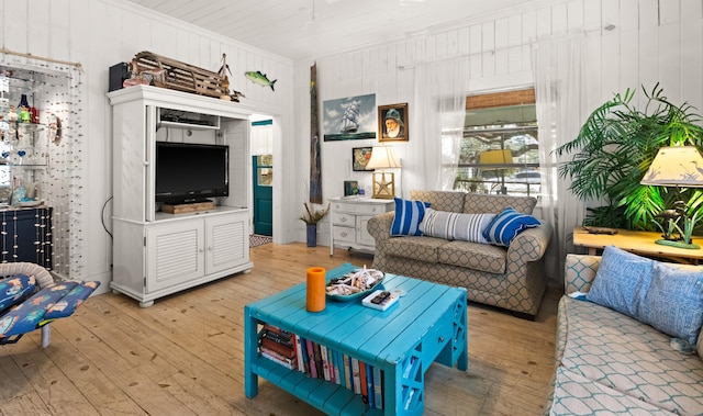 living area with light wood-style floors and crown molding