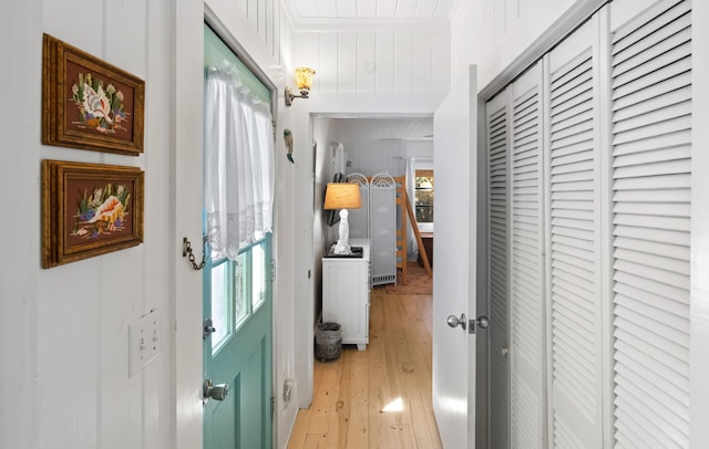 corridor with light wood-type flooring and wood ceiling