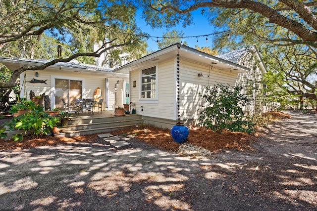 exterior space with a deck and metal roof