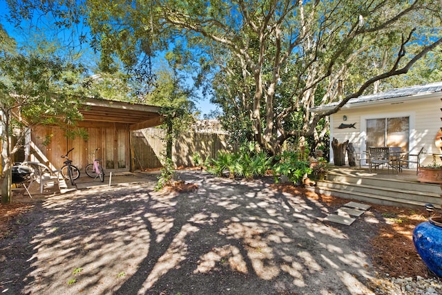 view of yard featuring fence and a wooden deck