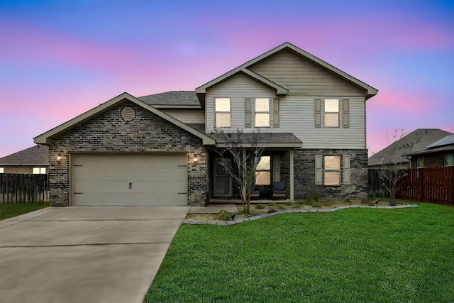 traditional home with a front lawn, an attached garage, fence, and concrete driveway