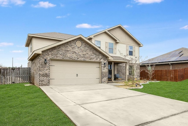 traditional-style house featuring a garage, brick siding, a front lawn, and fence