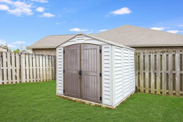 view of shed with a fenced backyard