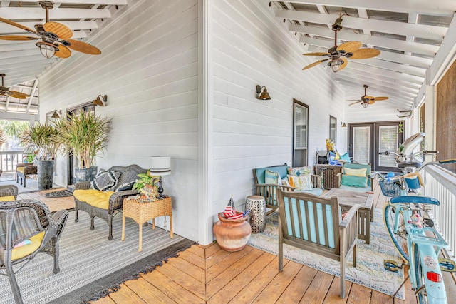 deck with outdoor lounge area and ceiling fan