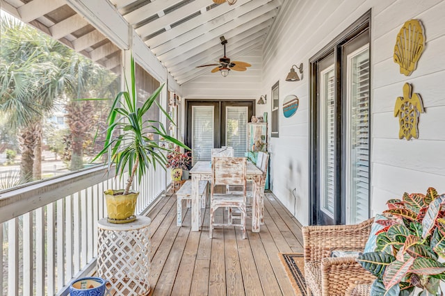 sunroom / solarium with lofted ceiling with beams, french doors, and ceiling fan