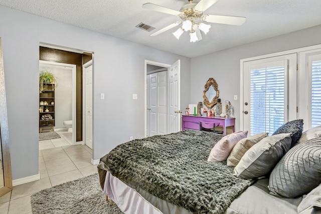 bedroom featuring light tile patterned floors, a ceiling fan, visible vents, a textured ceiling, and access to outside