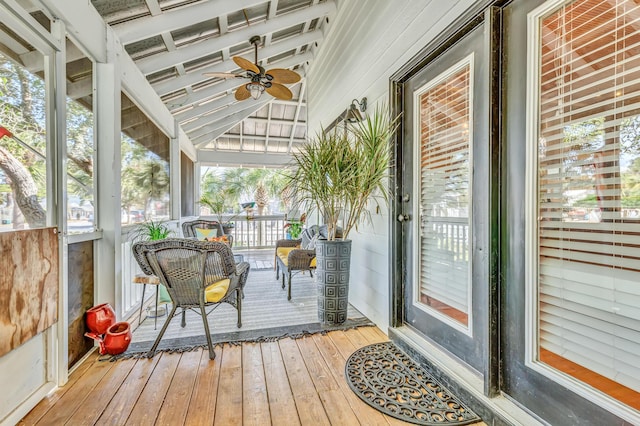 sunroom / solarium featuring lofted ceiling and a ceiling fan