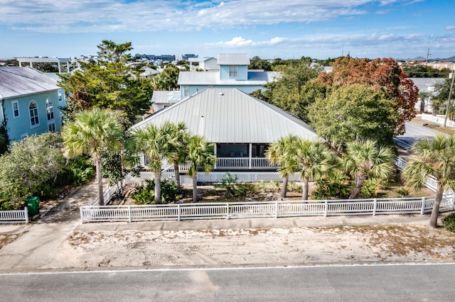 view of front of property with a fenced front yard and metal roof