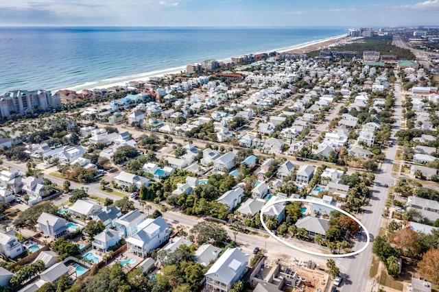 aerial view with a water view and a beach view