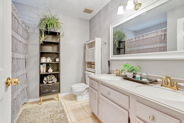 full bathroom with a sink, visible vents, toilet, and a textured ceiling