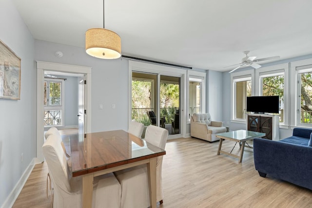 dining area with baseboards, a healthy amount of sunlight, ceiling fan, and light wood finished floors