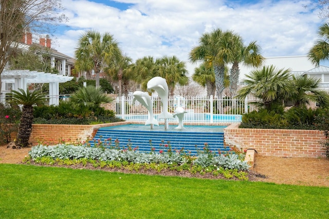 view of home's community featuring fence, a lawn, and a pergola