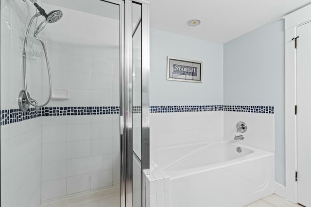 bathroom featuring a stall shower and a garden tub