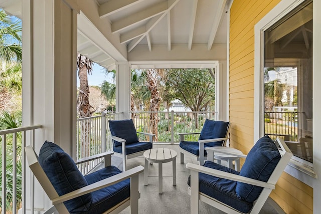 sunroom / solarium with a wealth of natural light and beam ceiling