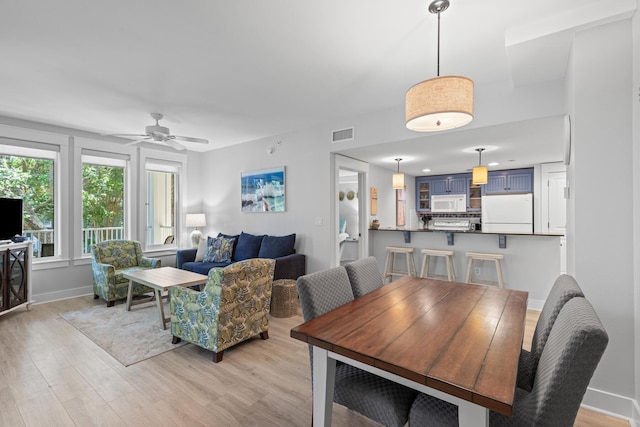 9100 Baytowne Wharf Blvd Unit 451, Miramar Beach, FL 32550 - dining space with light wood-type flooring, visible vents, a ceiling fan, and baseboards