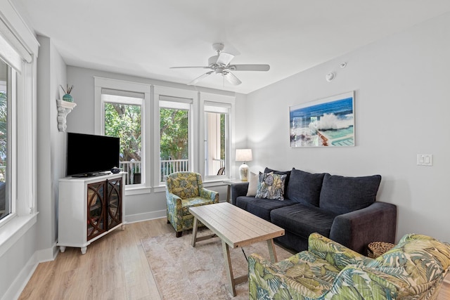 9100 Baytowne Wharf Blvd Unit 451, Miramar Beach, FL 32550 - living area featuring wood finished floors, a ceiling fan, and baseboards