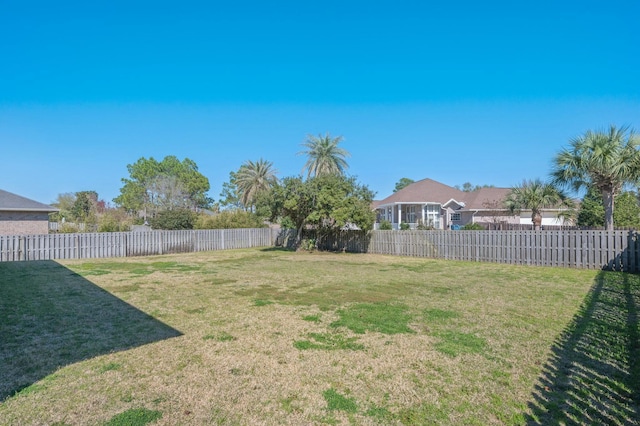 view of yard with a fenced backyard